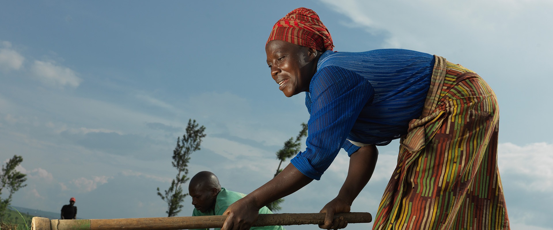 Shikiranya Juistine,43, and her husband, Eliazar Niyibizi, de-weed their onions at Rwoma B block farm in Mbararra. Shikiranya is part of Action Against Hunger's SIDA project which has helped her to access land and seed and tools to farm her onions.