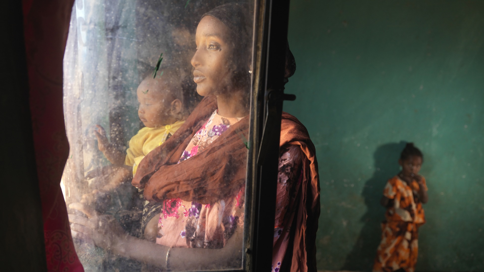 Darmi and her daughters inside their home.