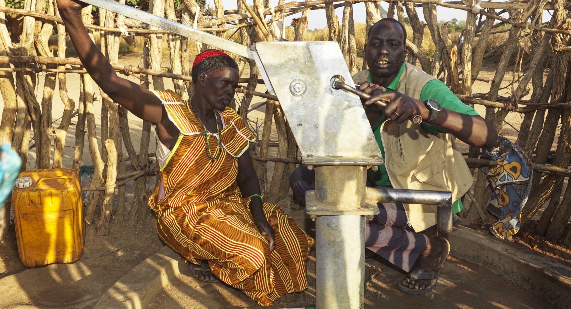 Nyanut works with a member of Action Against Hunger's team to maintain her community's borehole.