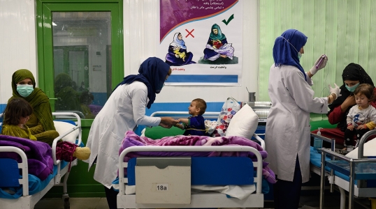 Nurses interact with acutely malnourished infants and their mothers in an inpatient ward at Action Against Hunger’s therapeutic feeding unit in Kabul’s Ahmad Shah Baba Mina area on April 15, 2023.