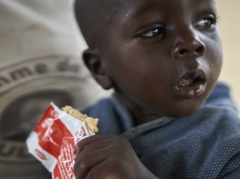 A young boy eats Plumpy'Nut, the peanut paste used to treat malnutrition.