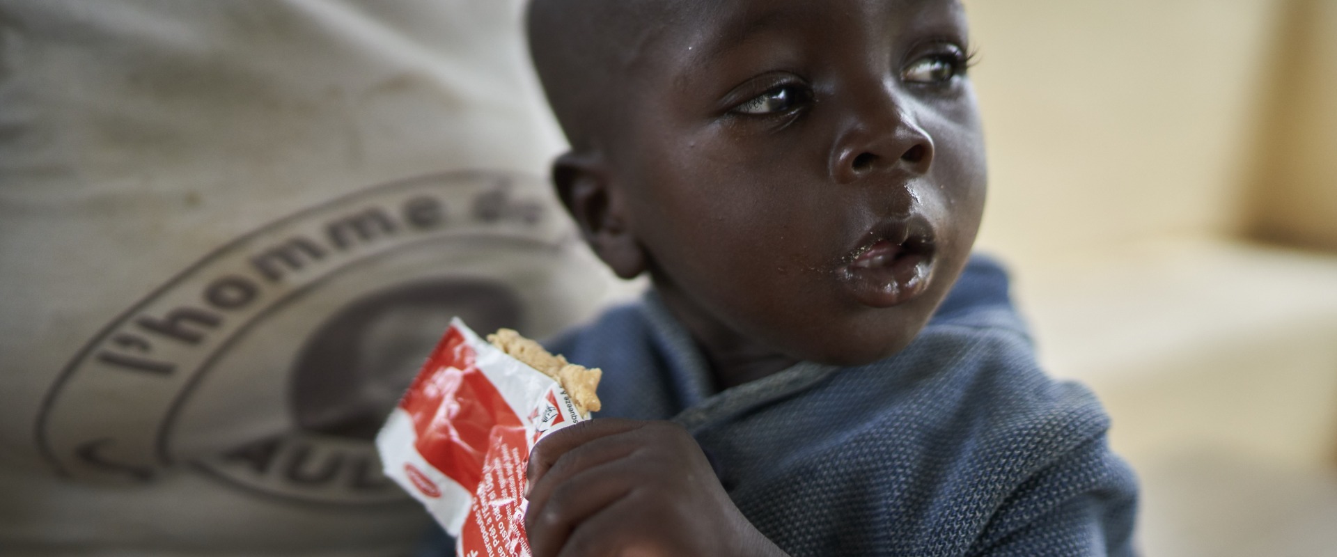 A young boy eats Plumpy'Nut, the peanut paste used to treat malnutrition.