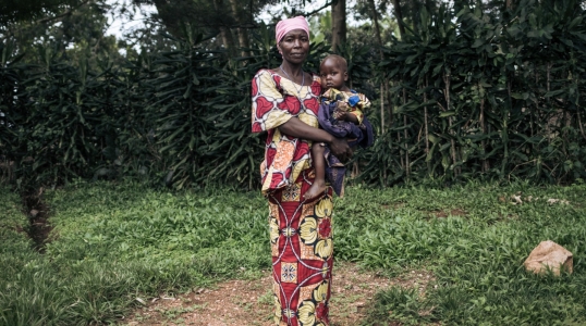 Georgine Dz'dha Nzale holds her 27-month-old son, David Wauba, who suffers from severe acute malnutrition, near the Drodro Health Center in Ituri, northeastern Democratic Republic of Congo.