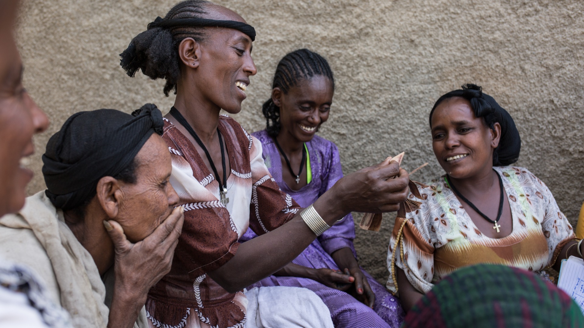 Women meet for their weekly gathering of their community savings and loans group.
