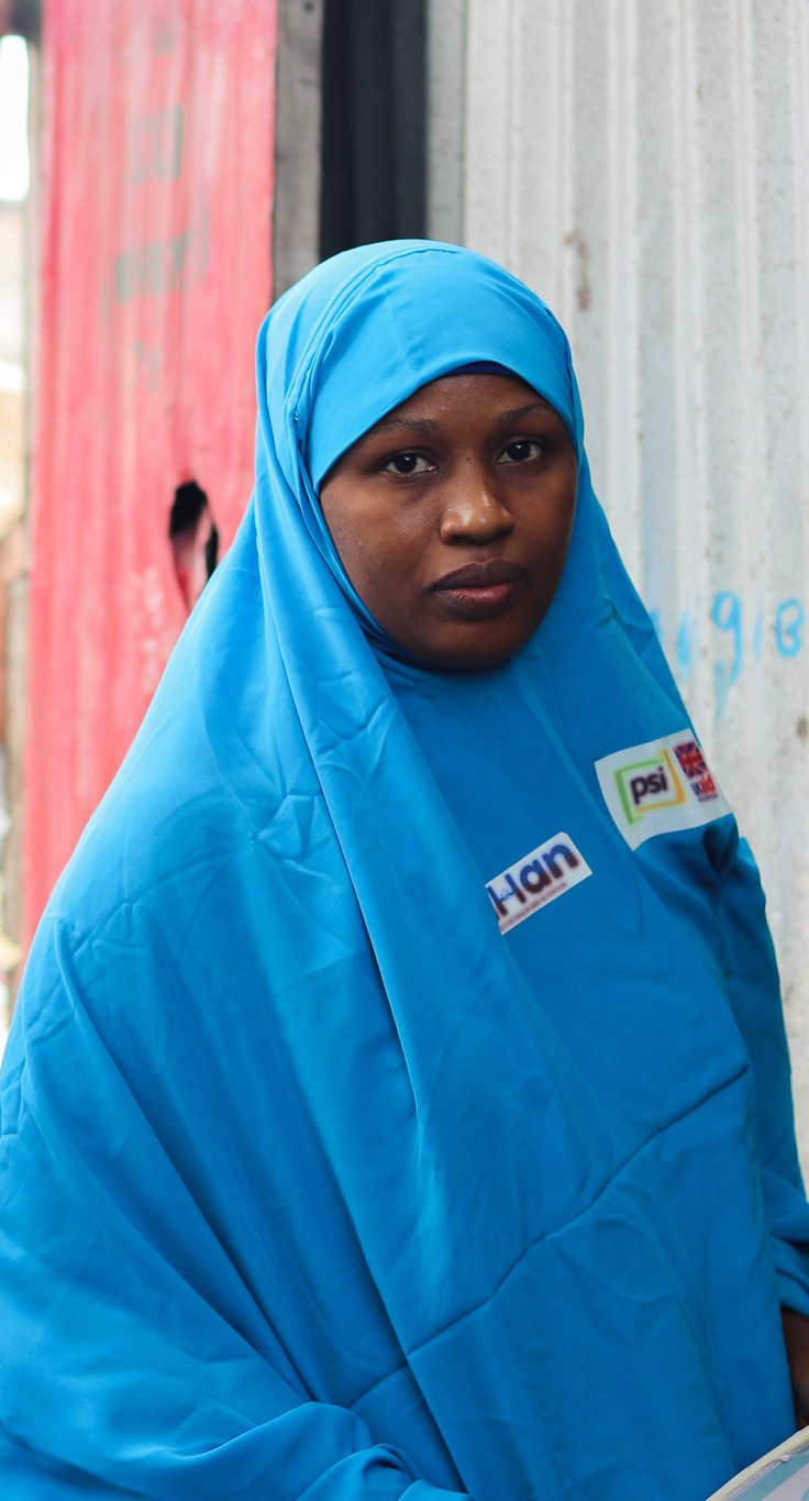 Two Female Community Influencers, Fardosa (left) and Amina (right), pose before they head into a home to meet with a mother.