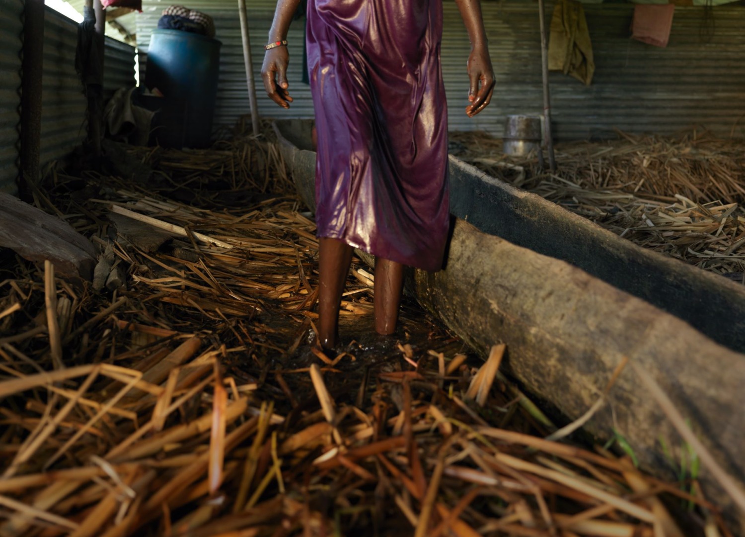 Womn walking through flooded house in South Sudan