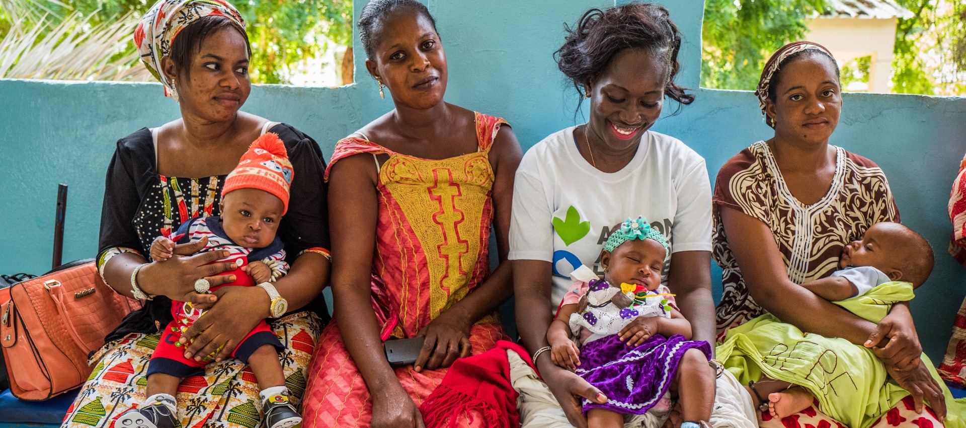 Action Against Hunger midwife, Sophie Faye, sits with mothers and their children after teaching a nutrition class at the Matam Health Center.