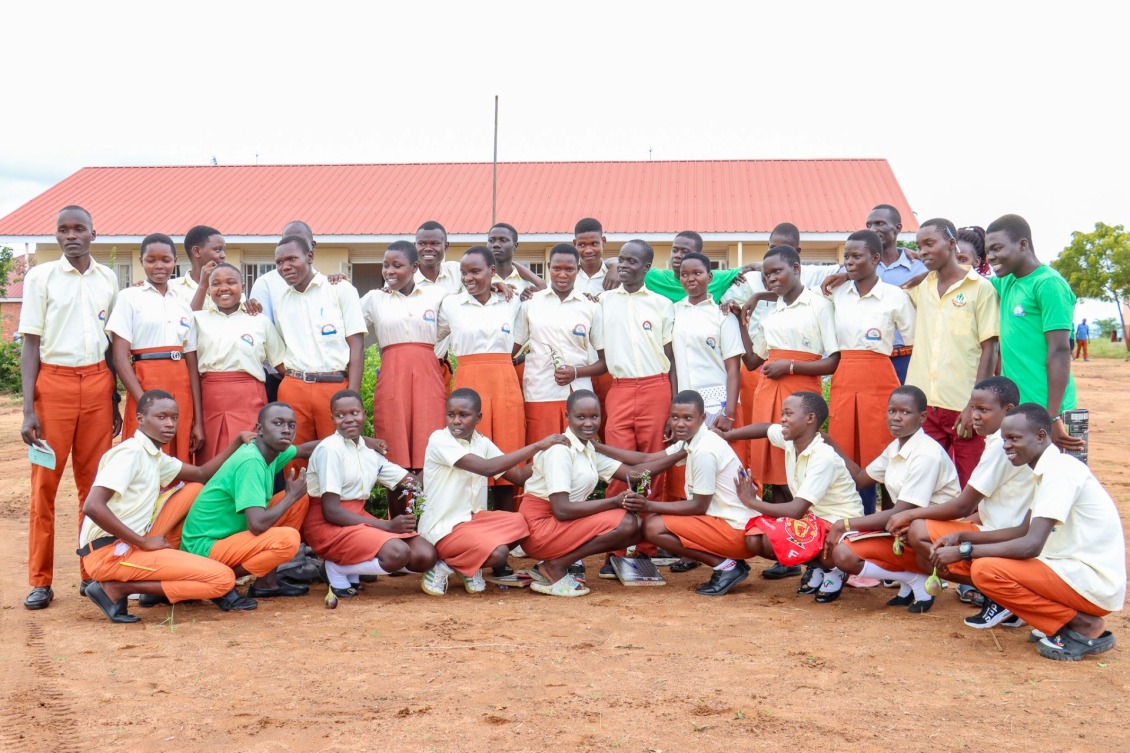 Patience and her team pose their trophy from the Karamoja Green School debate.