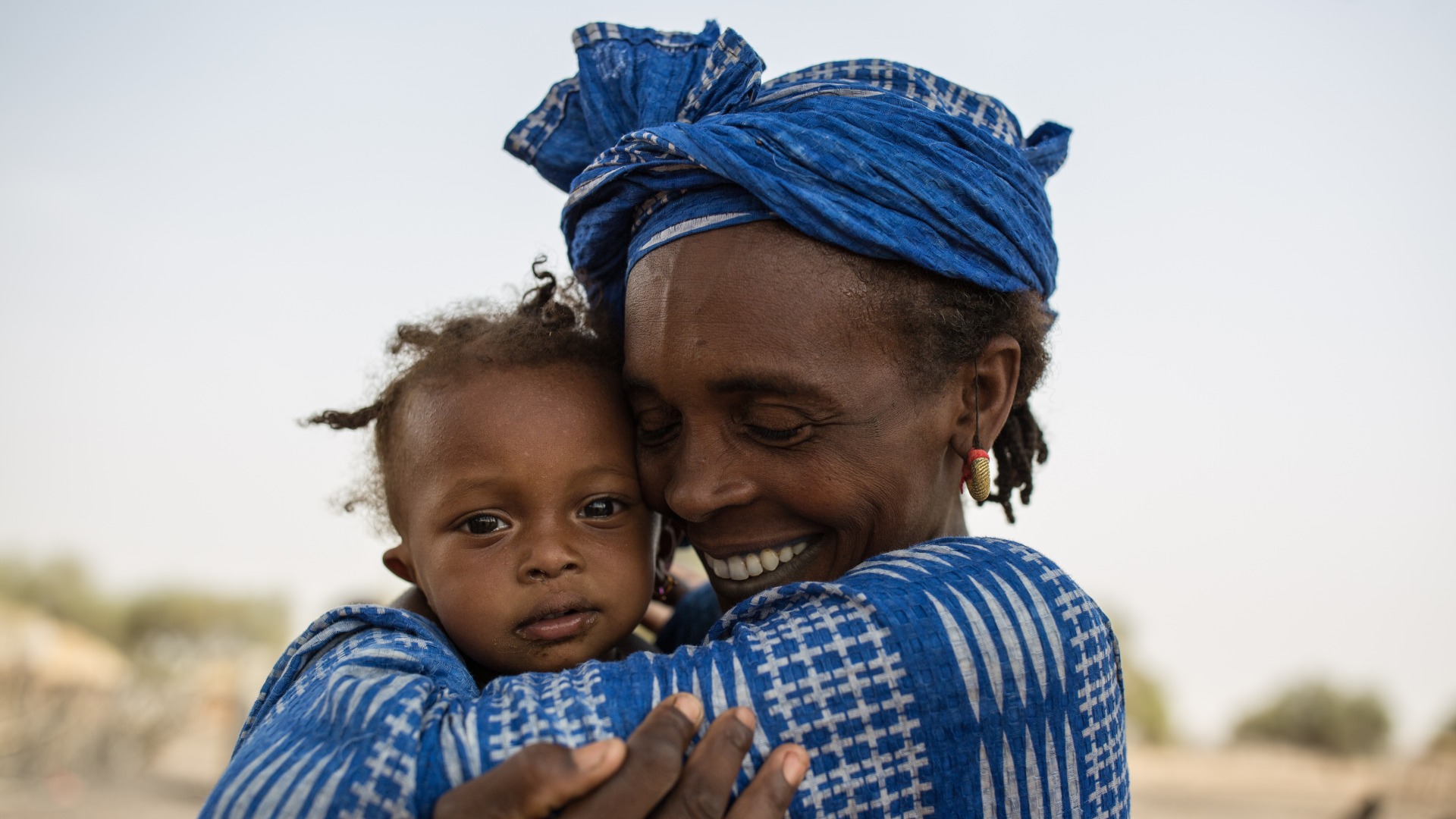 A woman hugs her daughter