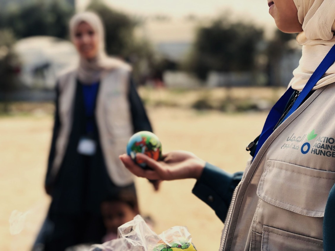 A staff member holds a child's toy. 