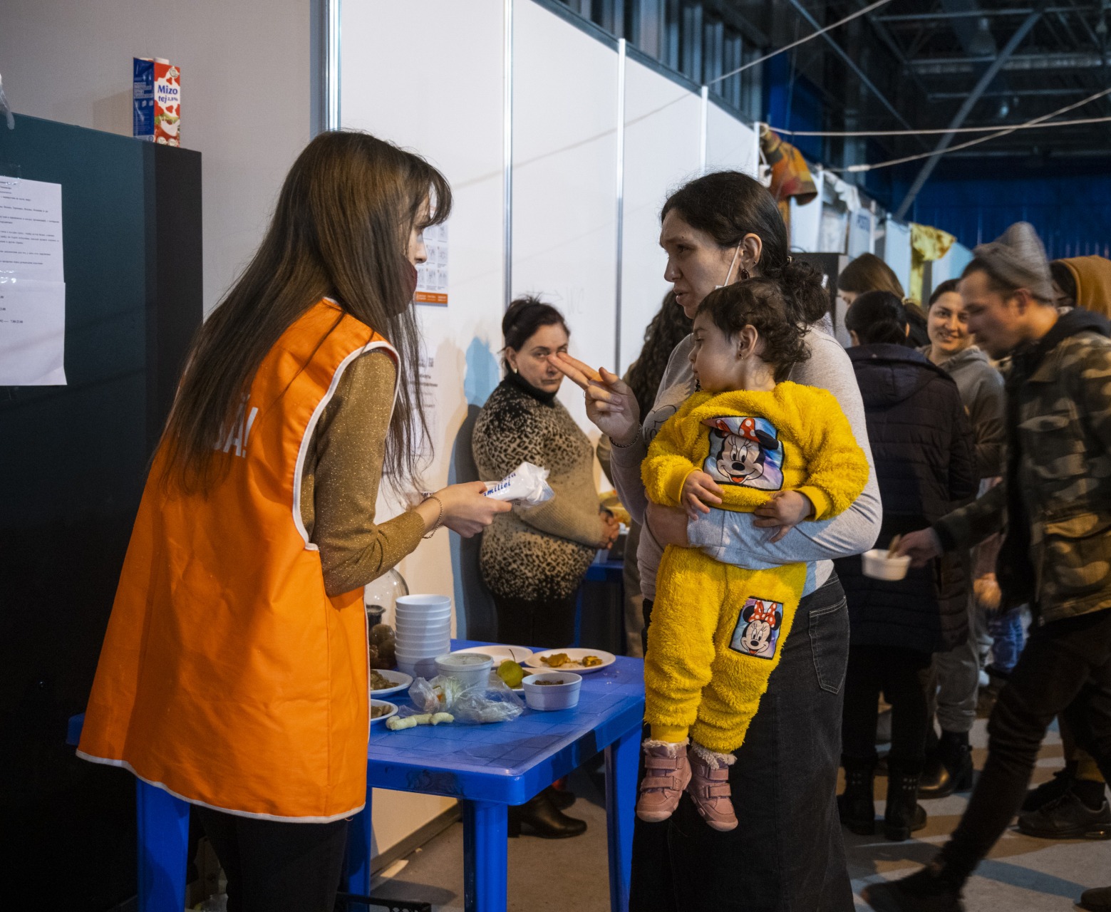 A woman asks for help at a shelter for Ukrainian refugees.