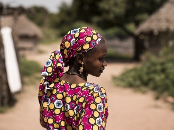 Hawa Coulibaly, 30, a community health worker walks in Kourougue village, Mali.