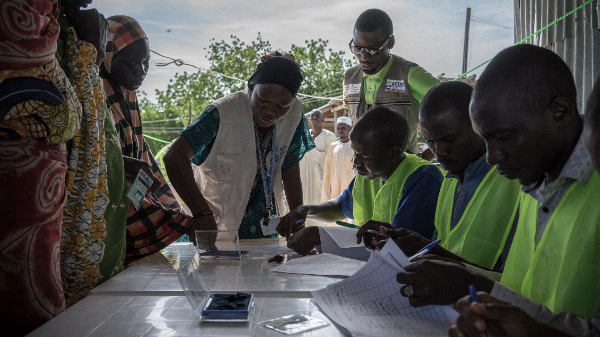 Action Against Hunger staff conduct a distribution of hundreds of shelter kits and hygiene kits to displaced people in Monguno, Borno State, Nigeria