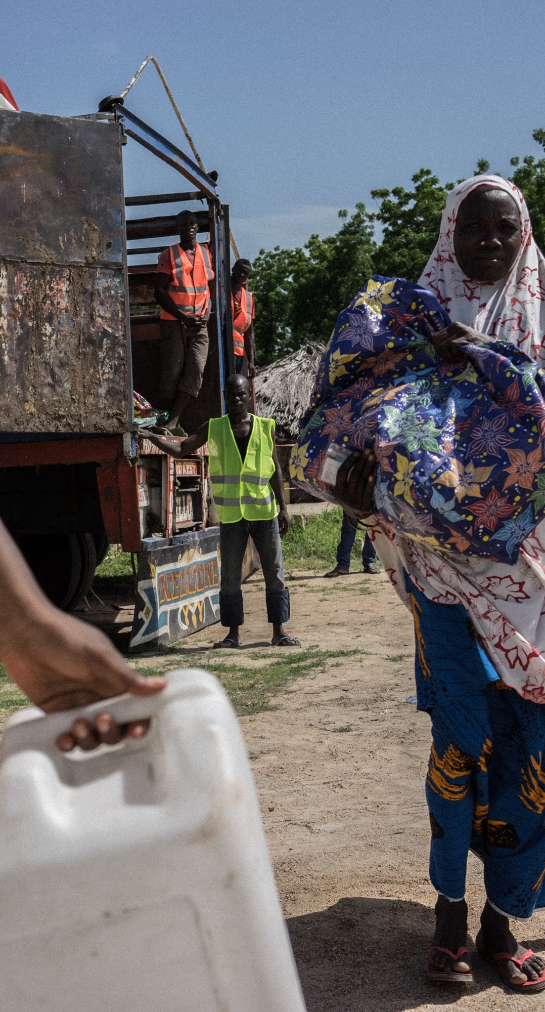 Action Against Hunger staff conduct a distribution of hundreds of shelter kits and hygiene kits to displaced people in Monguno, Borno State, Nigeria