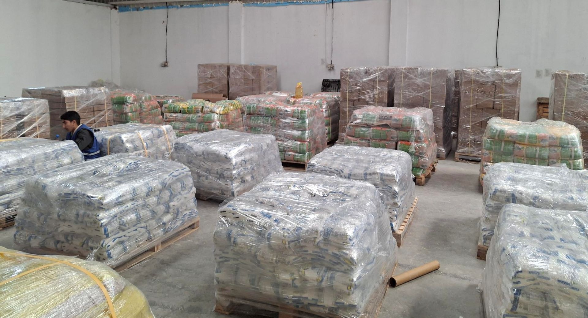 Pallets of food sit in a warehouse, waiting to be granted access into Gaza.