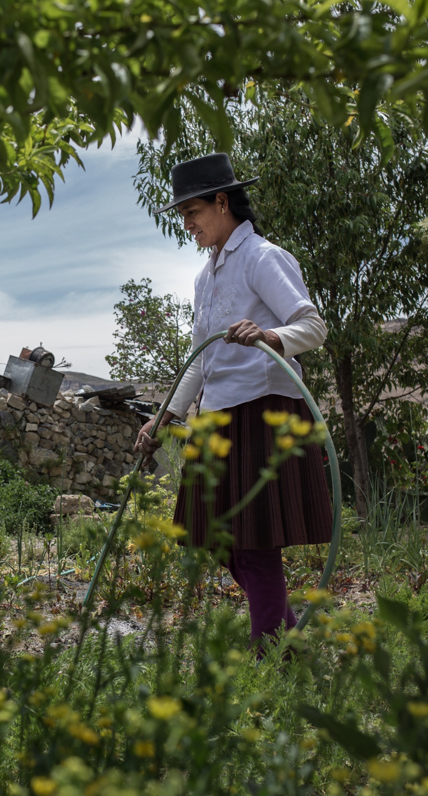 A woman cultivates her garden.