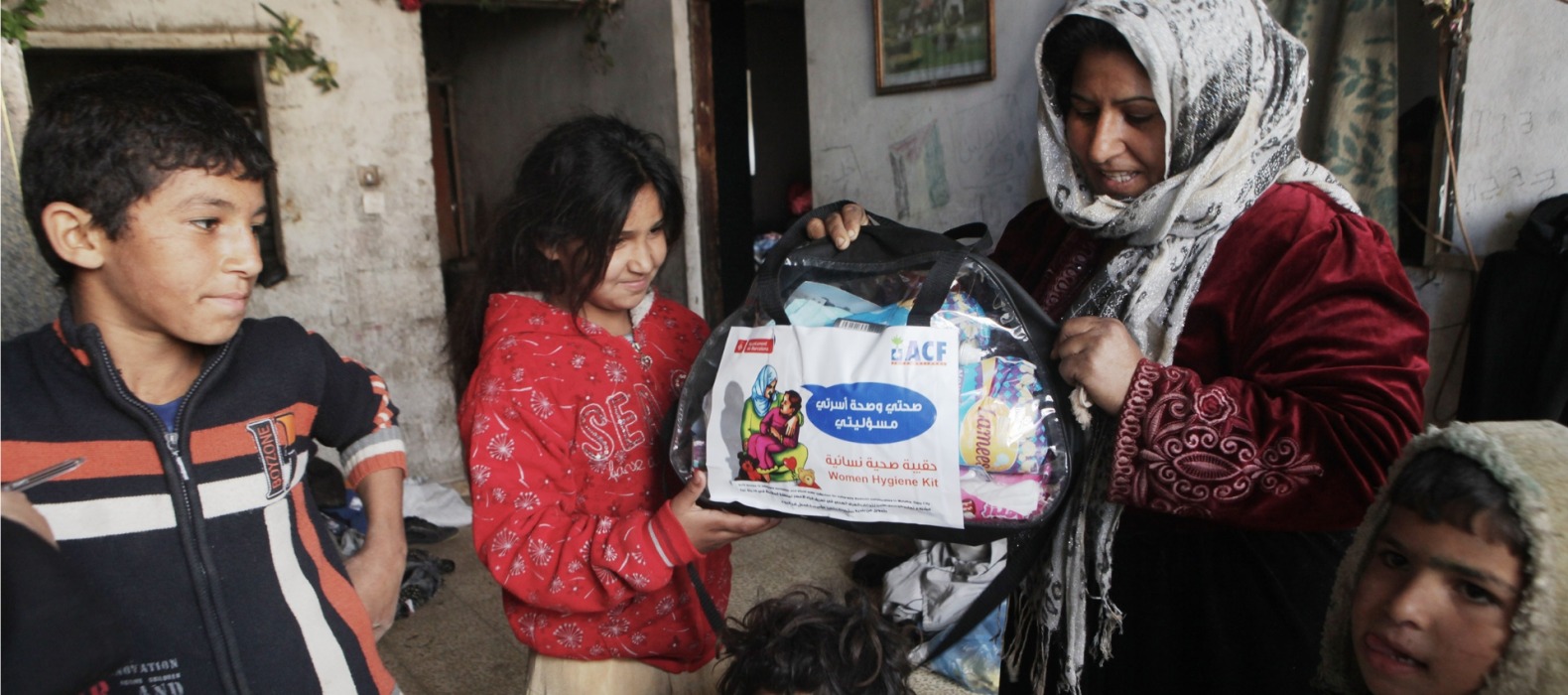 A family receives an emergency kit from Action Against Hunger