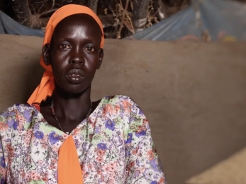 A woman looking into camera in South Sudan