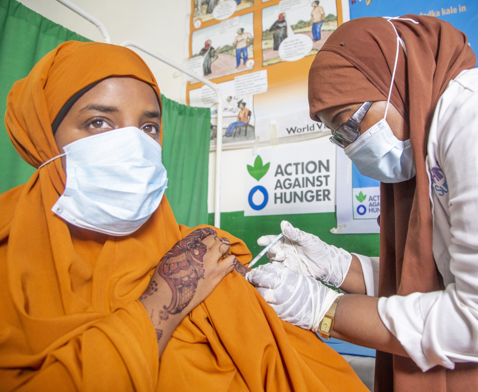 A nurse at Waberi Health Centre administering the second dose of COVID-19 vaccina jab to a young lady.