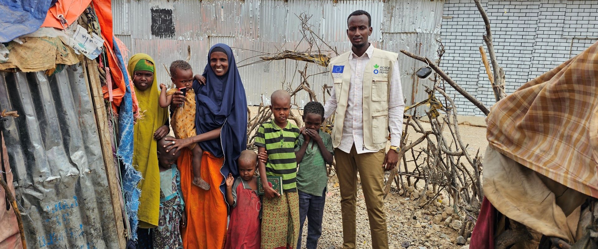 A community health worker with a woman and five children in Somalia.